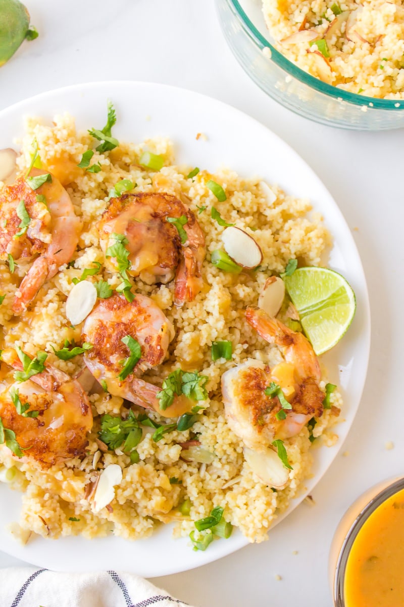 plate of shrimp with couscous and ginger orange sauce
