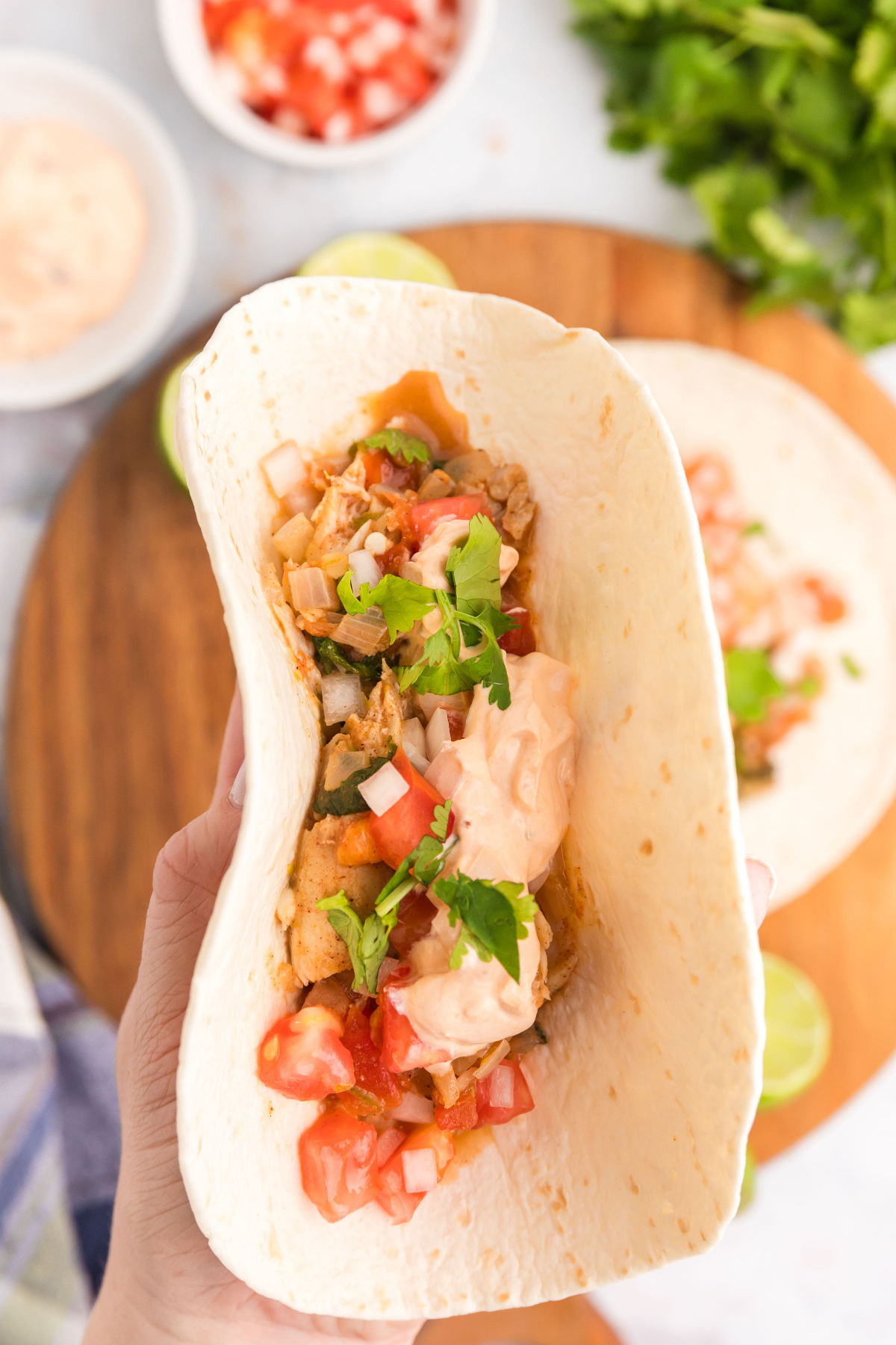 hand holding snapper taco open faced