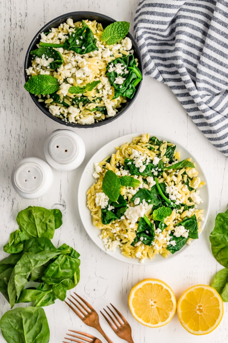 spinach with orzo and feta in bowls