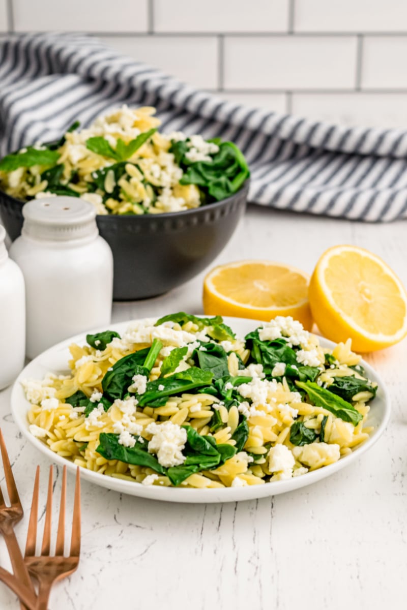 spinach with orzo and feta on a plate
