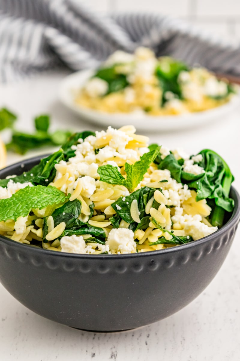 spinach with orzo and feta in a bowl