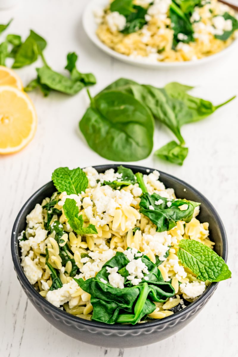 spinach with orzo and feta in a bowl