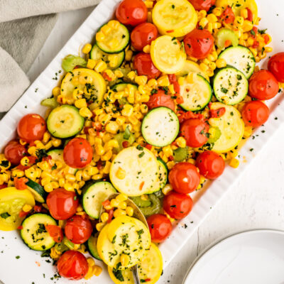 summer squash with cherry tomatoes on a platter