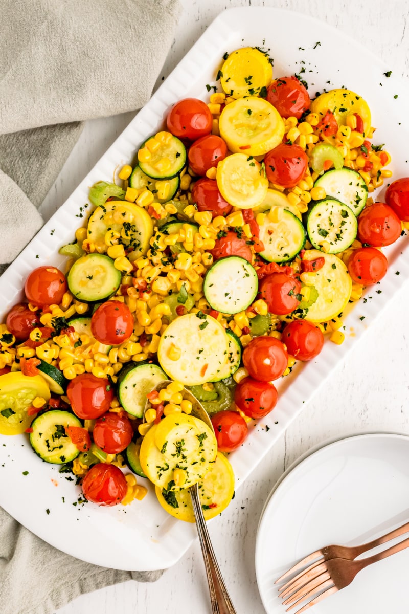summer squash with cherry tomatoes on a platter