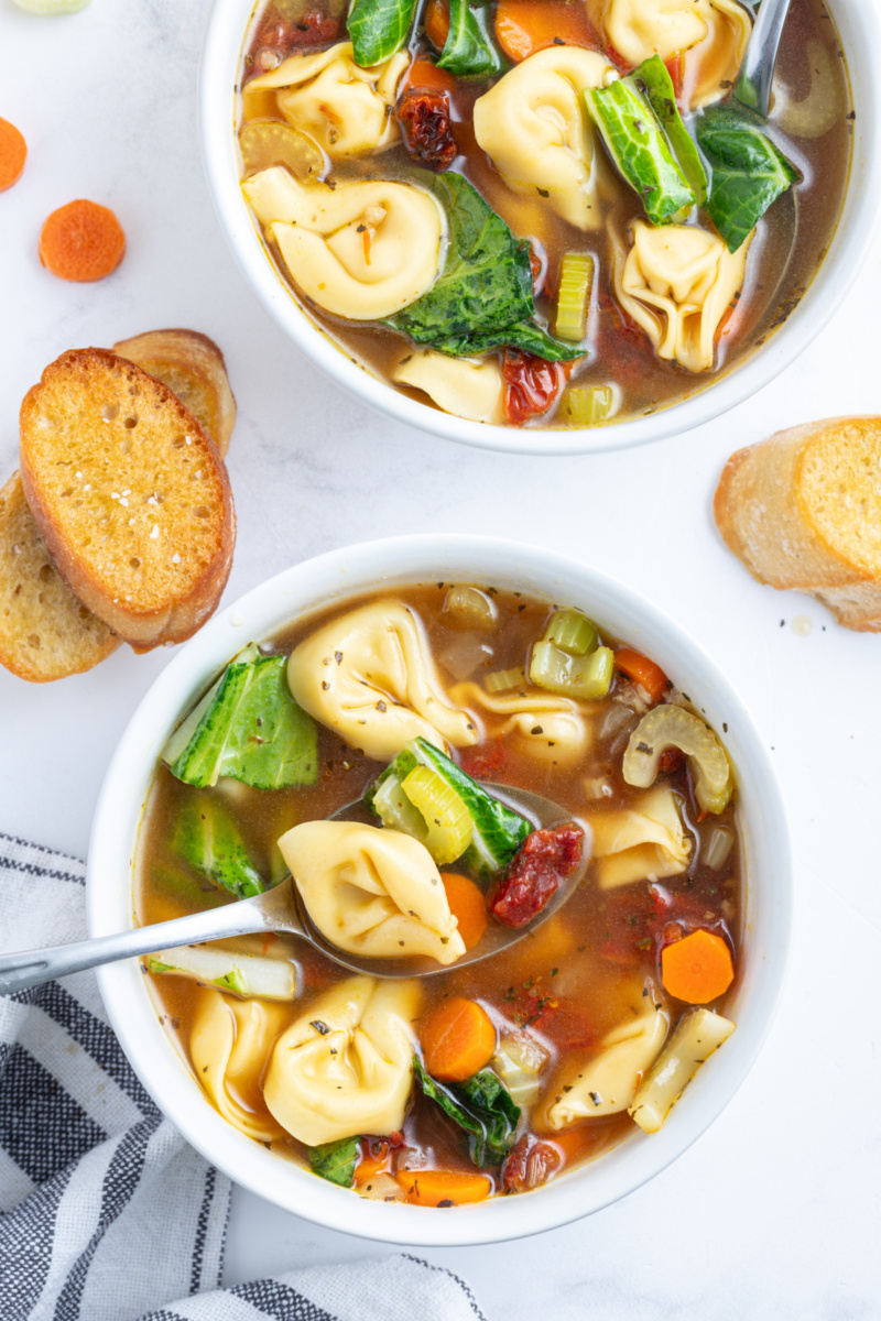 overhead shot of two bowls of sundried tomato tortellini soup