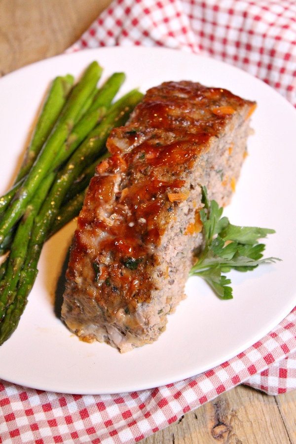 turkey meatloaf slice on a plate with asparagus