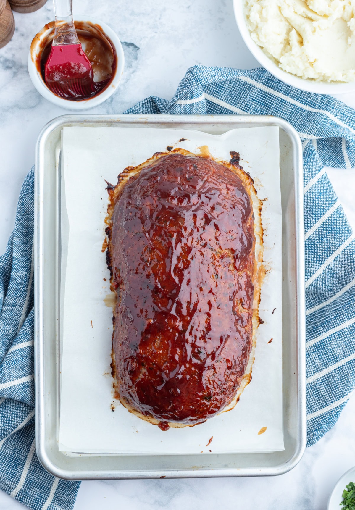 Moist Ground Turkey Meatloaf made with lean turkey, veggies, and BBQ sauce for flavor. Healthy, high protein, and never dry. Easy weeknight dinner recipe. overhead shot of ground turkey meatloaf on baking pan