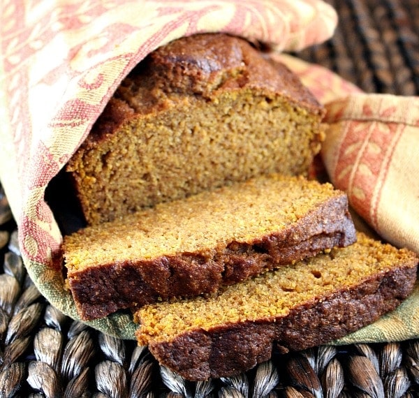 Whole Wheat Olive Oil Pumpkin Bread sliced and wrapped in a cloth napkin