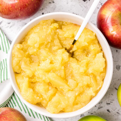 white bowl of applesauce with spoon