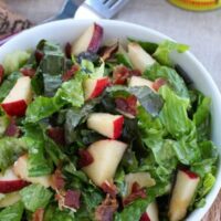 apple bacon salad in a white bowl