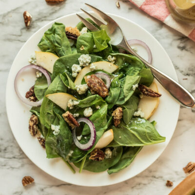 autumn salad on white plate with fork