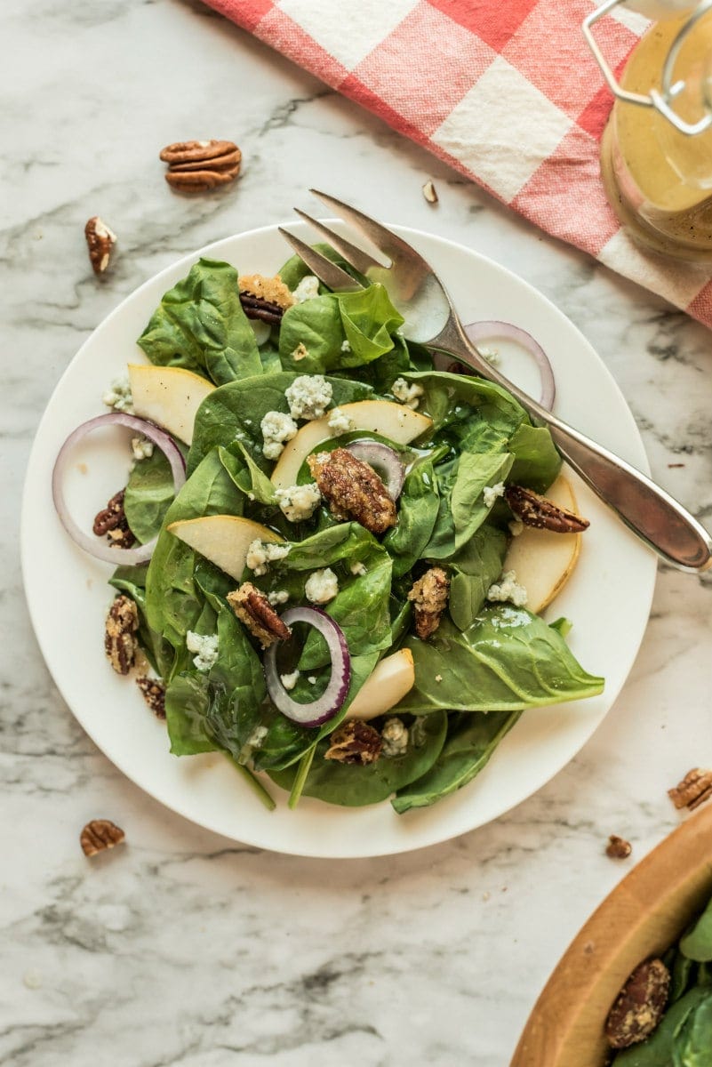 autumn salad on white plate with fork