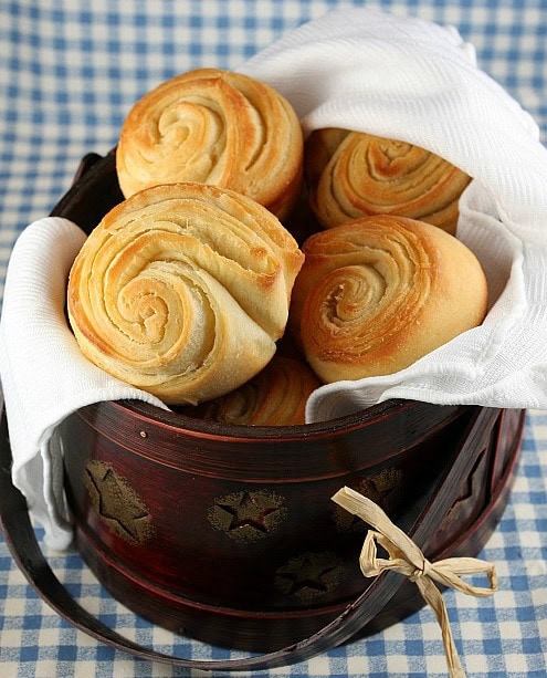 flaky dinner rolls in a serving container