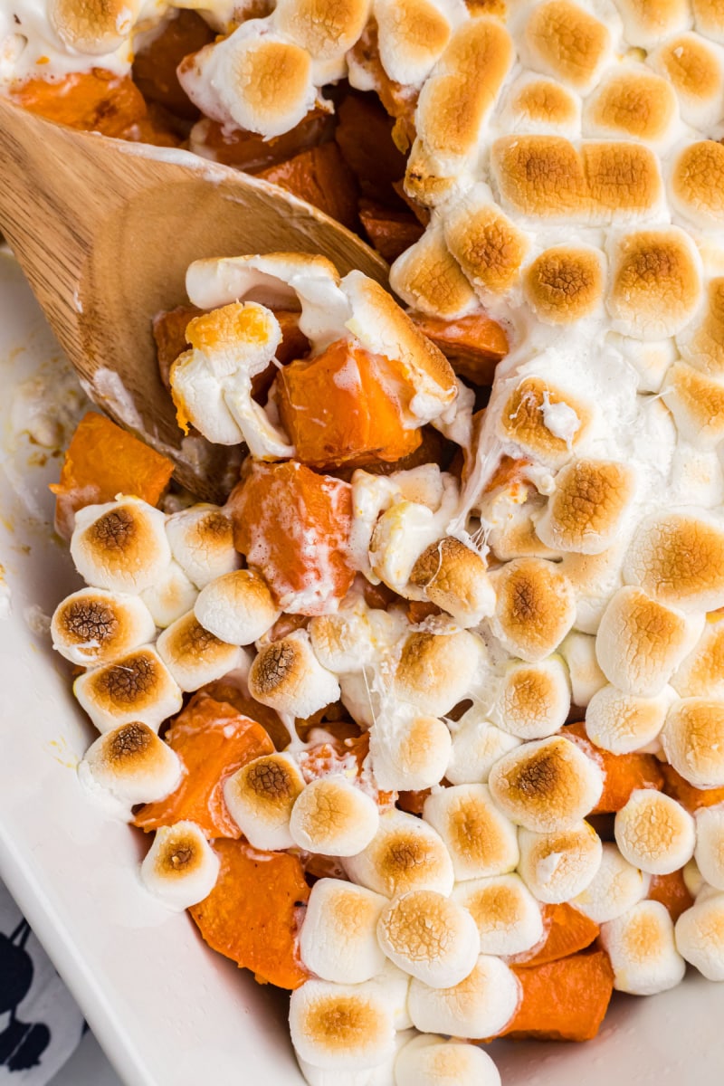 caramelized yams with marshmallows with spoon in dish