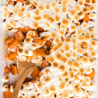 spooning out caramelized yams with marshmallows