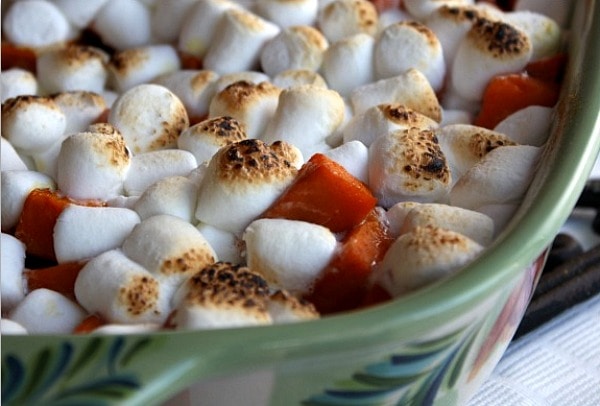 yams with marshmallows in green casserole dish