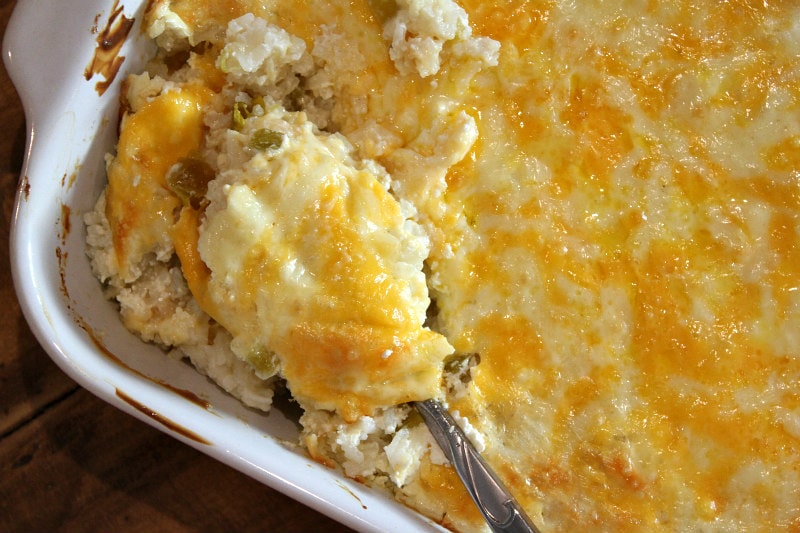 Chile Cheese Rice recipe from RecipeGirl.com #chile #cheese #rice #casserole #side #dish #sidedish #recipe #mexican #RecipeGirl Spooning out Chile Cheese Rice