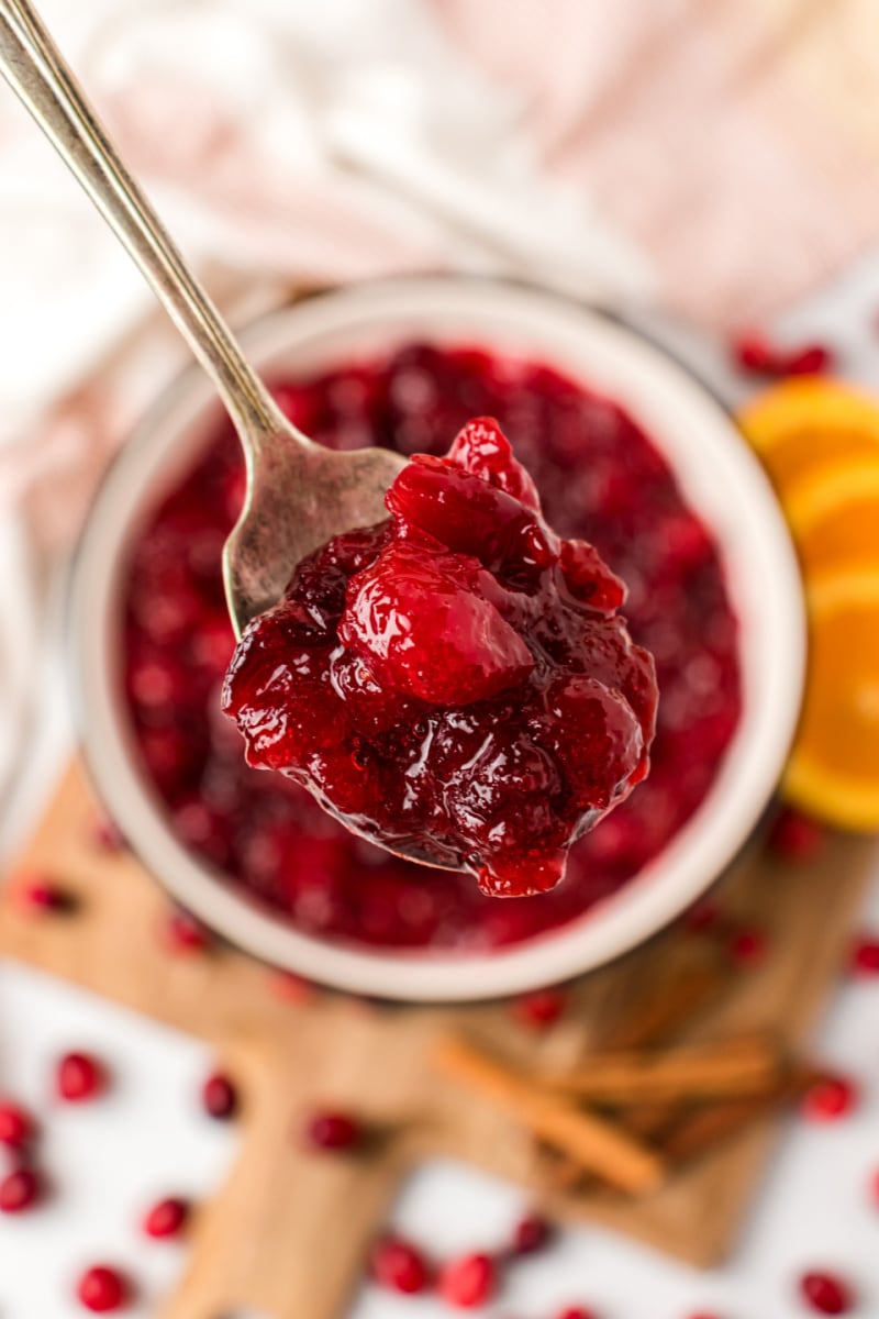 spoonful of cinnamon cranberry sauce over bowl