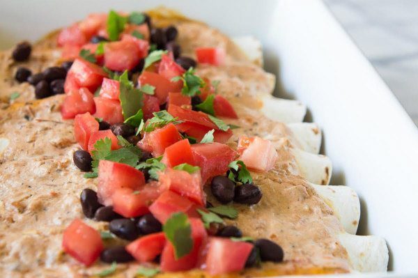 Easy Black Bean Enchiladas recipe from RecipeGirl.com #easy #blackbeans #enchiladas #recipe #RecipeGirl Easy Black Bean Enchiladas in a dish