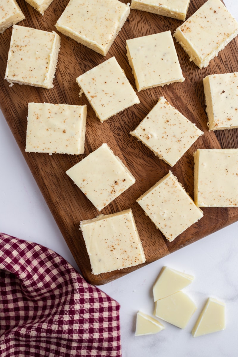 cut up pieces of eggnog fudge on a cutting board