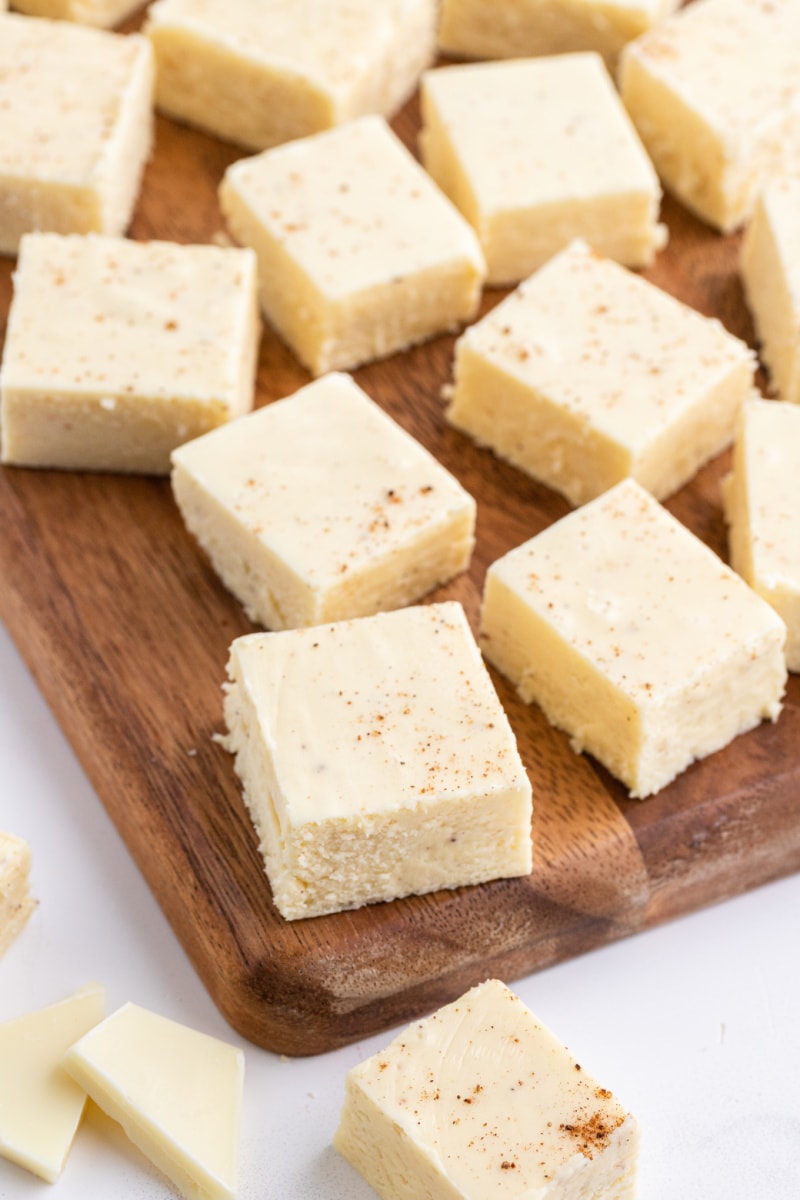 several pieces of eggnog fudge on a board