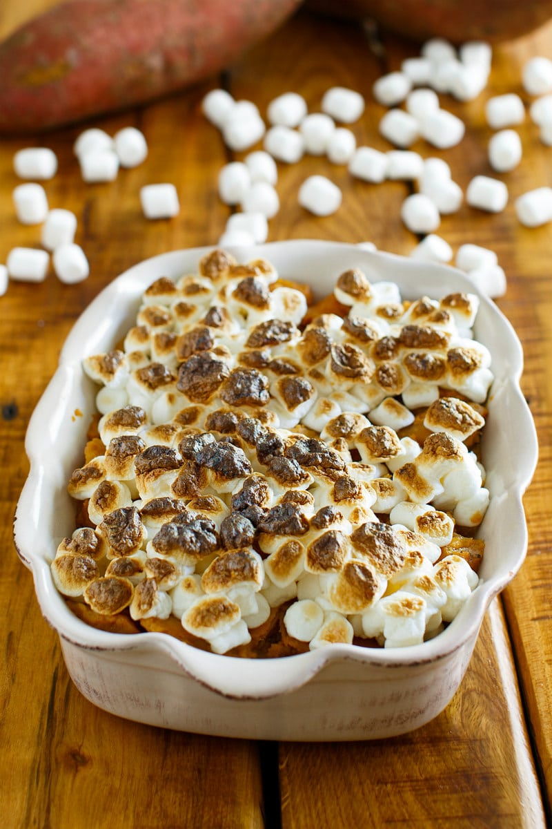glazed sweet potatoes in a casserole dish with toasted marshmallows