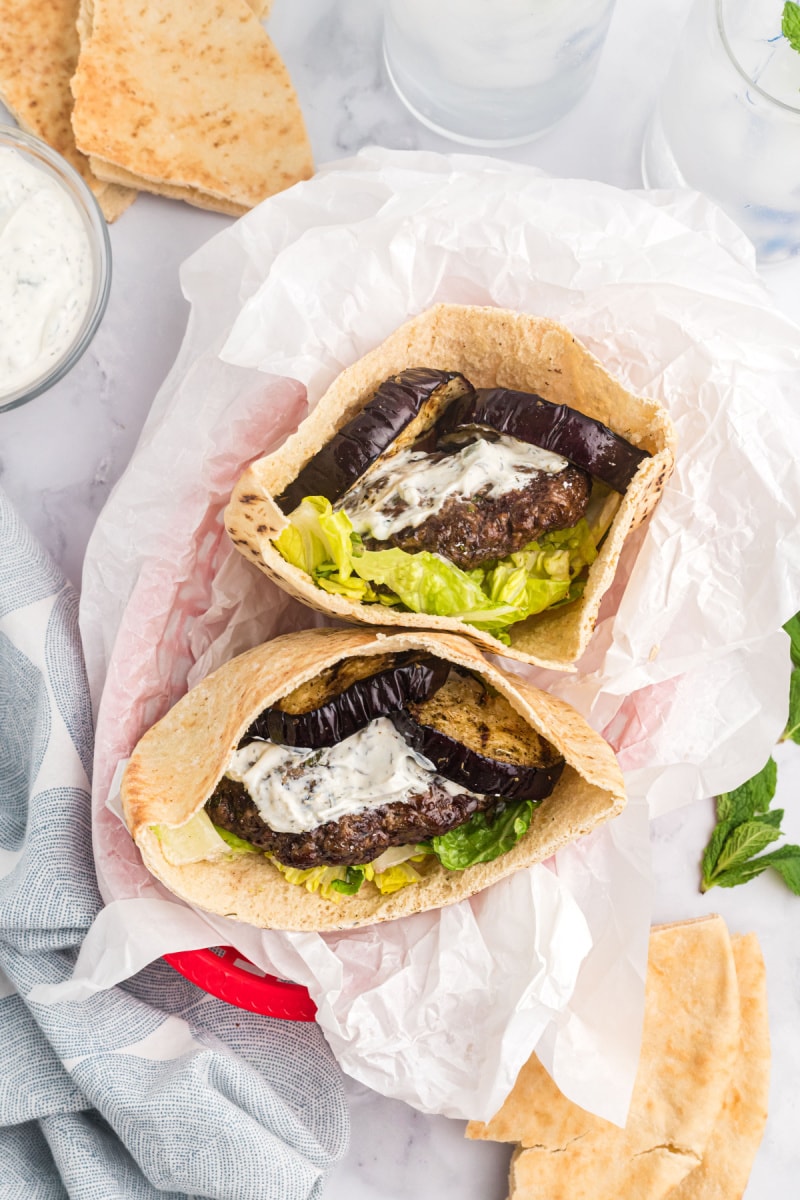 two greek inspired burgers in pita bread