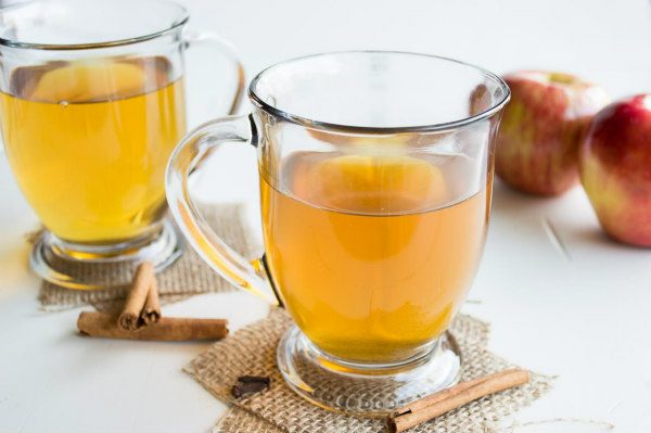 two mugs of hot spiced cider