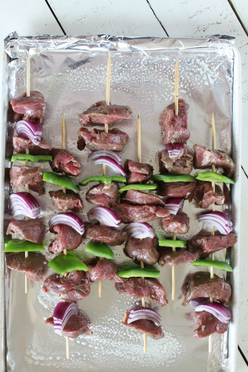 skewers of lamb souvlaki on baking sheet ready for broiling