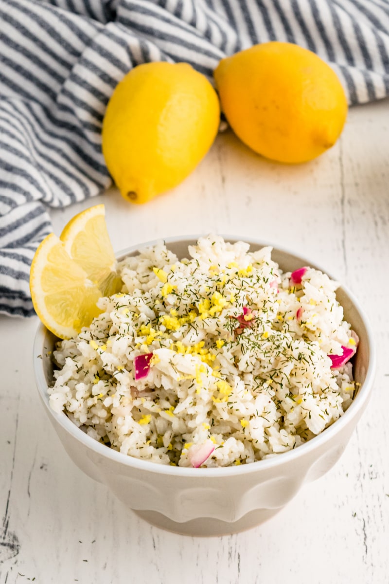 bowl of lemon dill rice garnished with lemon