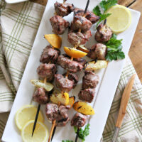 lemon garlic lamb kebabs on a white plate