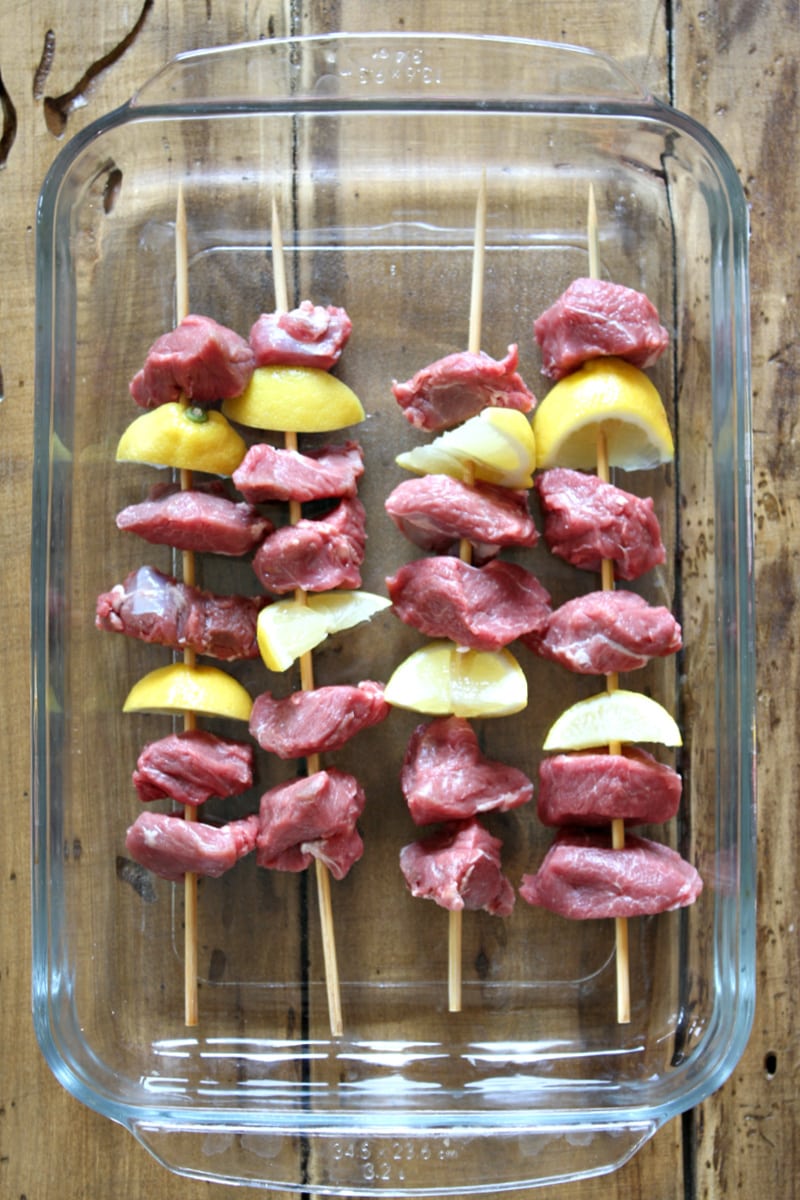 Lemon garlic lamb kebabs in a pan ready for marinade