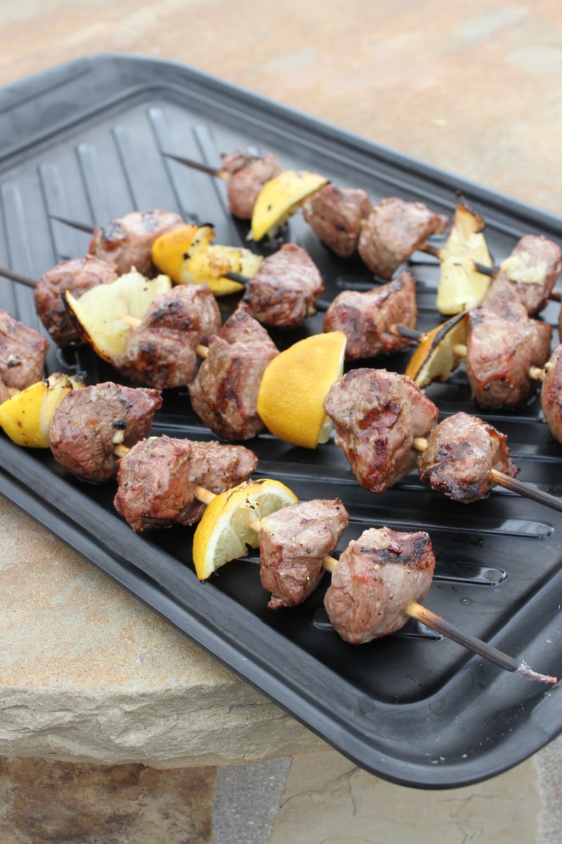 lemon garlic lamb kebabs on a grill platter