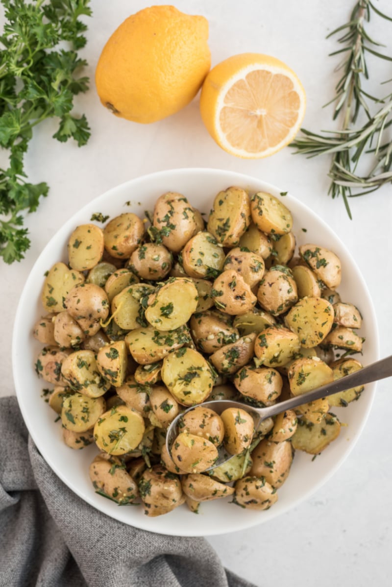 potatoes in bowl tossed with herbs