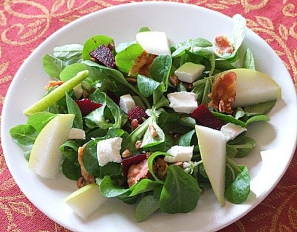 Pear, Goat Cheese, Beet and Walnut Green Salad Pear, Goat Cheese, Beet and Walnut Green Salad in a bowl