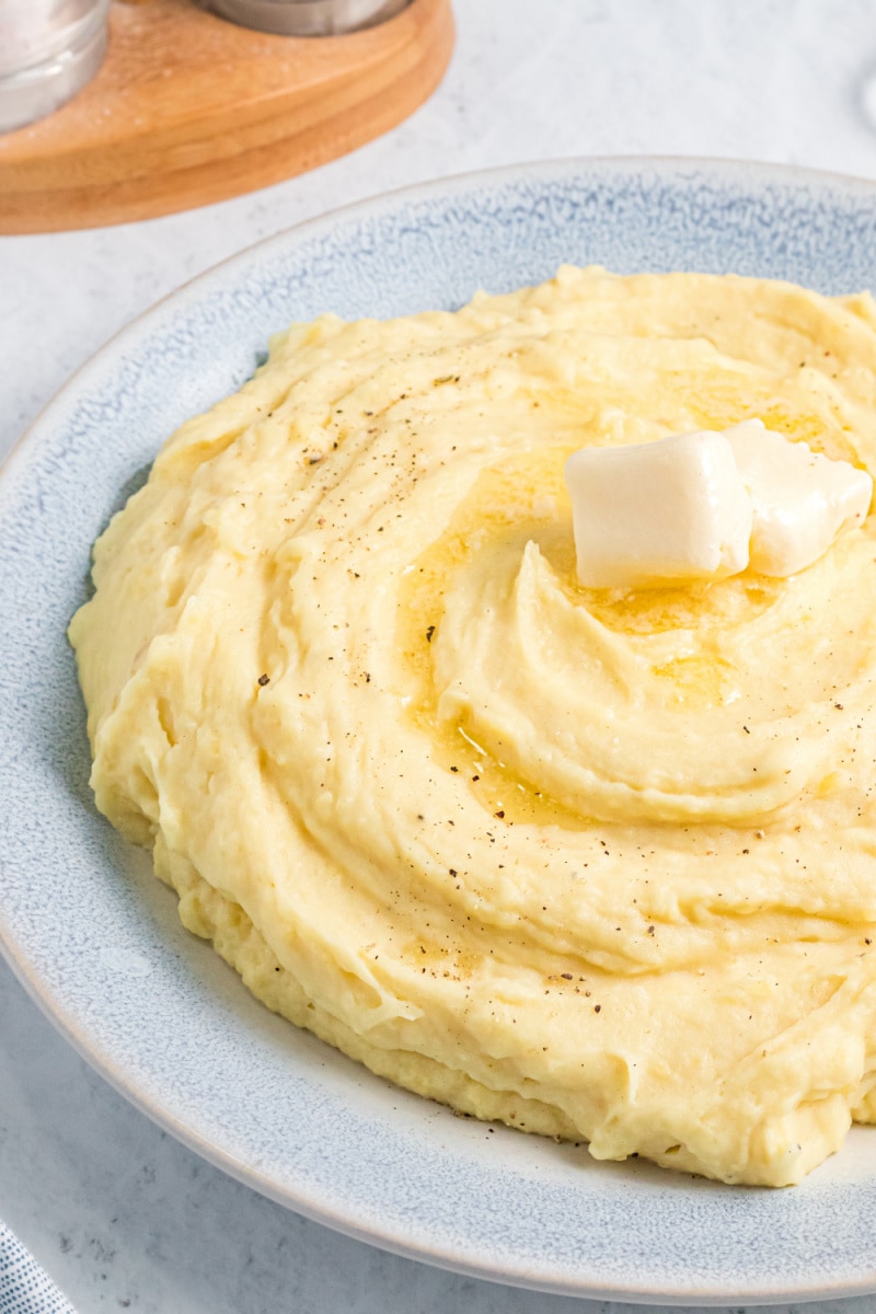 mustard mashed potatoes in a bowl with butter