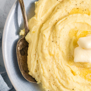 mashed potatoes in bowl with butter and spoon