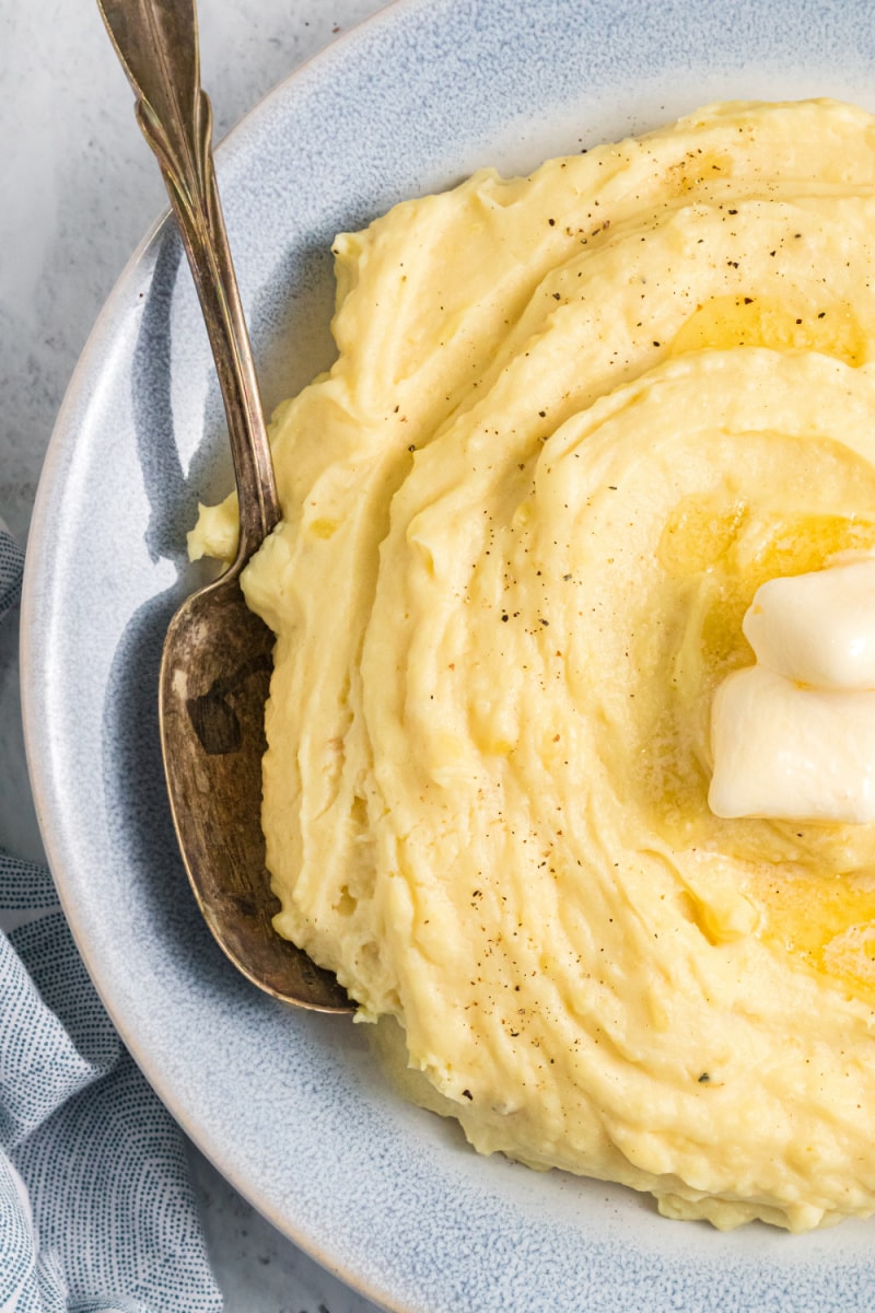 mashed potatoes in bowl with butter and spoon