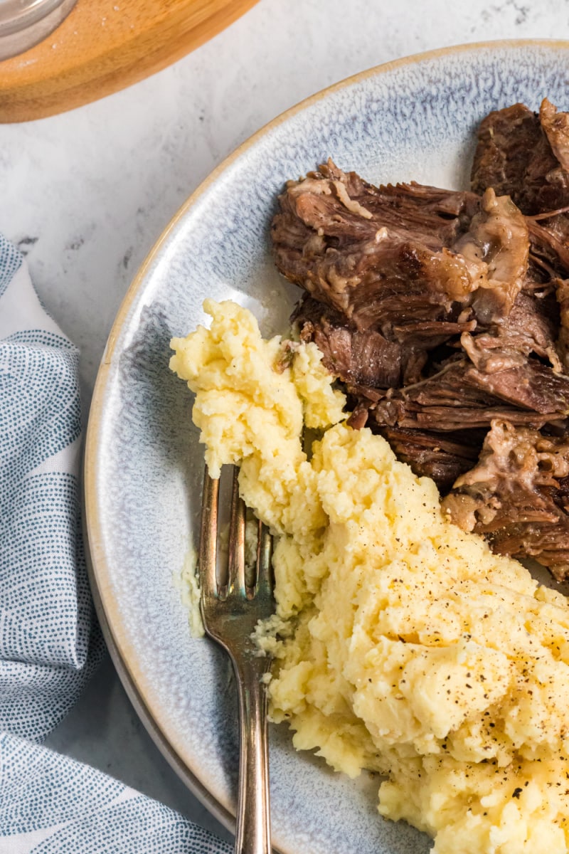 mashed potatoes on plate with pot roast