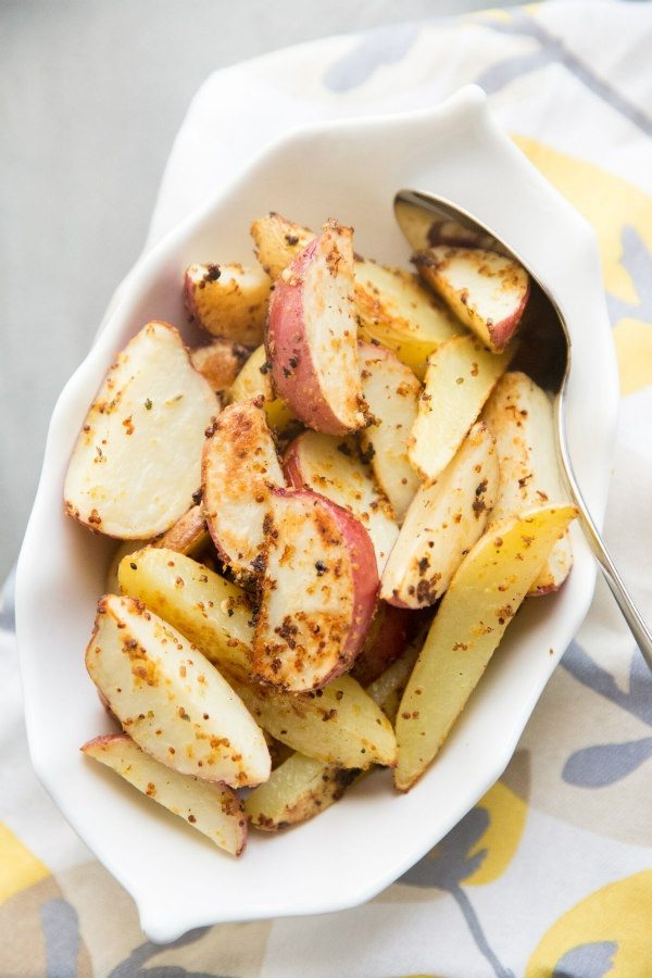 Mustard Roasted Potatoes recipe from RecipeGirl.com #mustard #roasted #potatoes #recipe #RecipeGirl Mustard Roasted Potatoes in a white dish