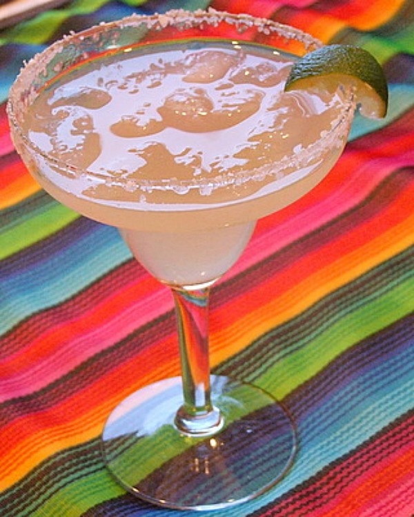 margarita in glass with colorful mexican blanket background