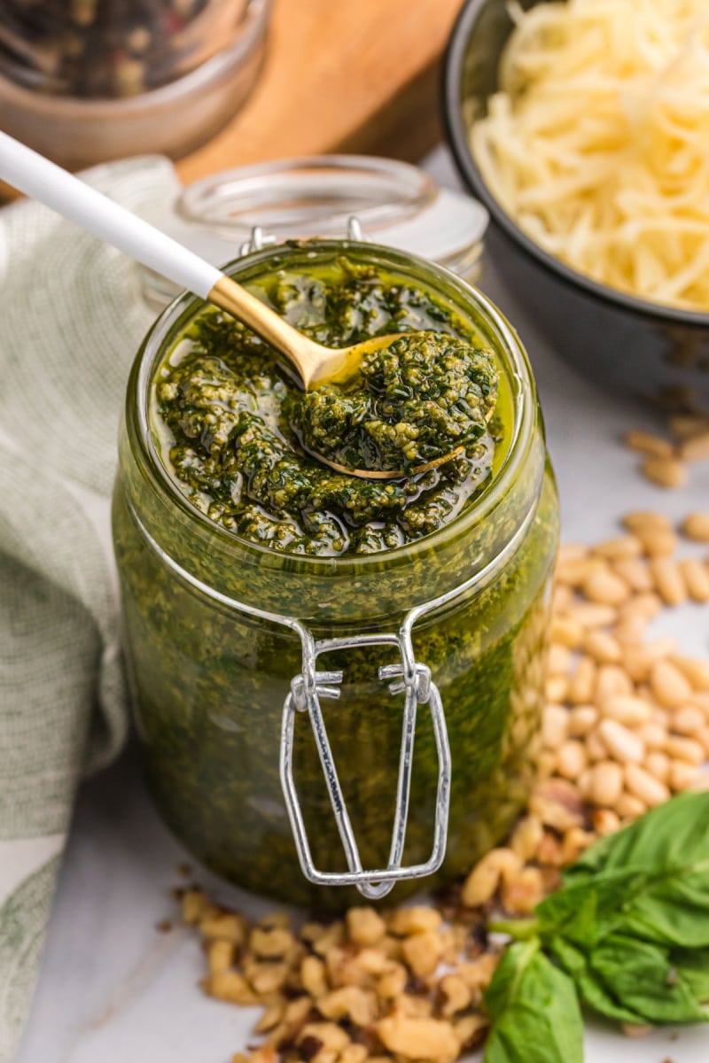 spoon in pesto sauce in jar