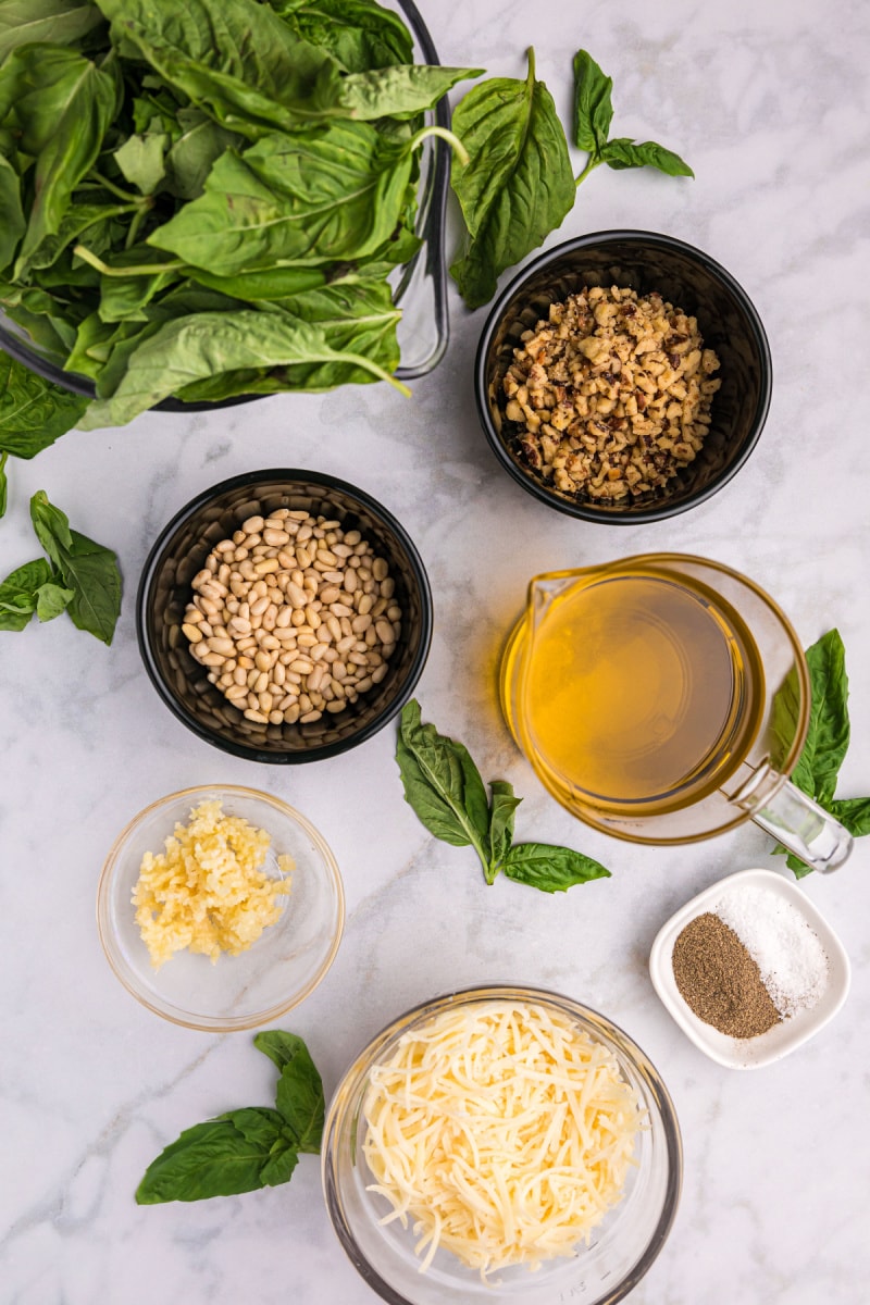 ingredients displayed for making pine nut and walnut pesto sauce