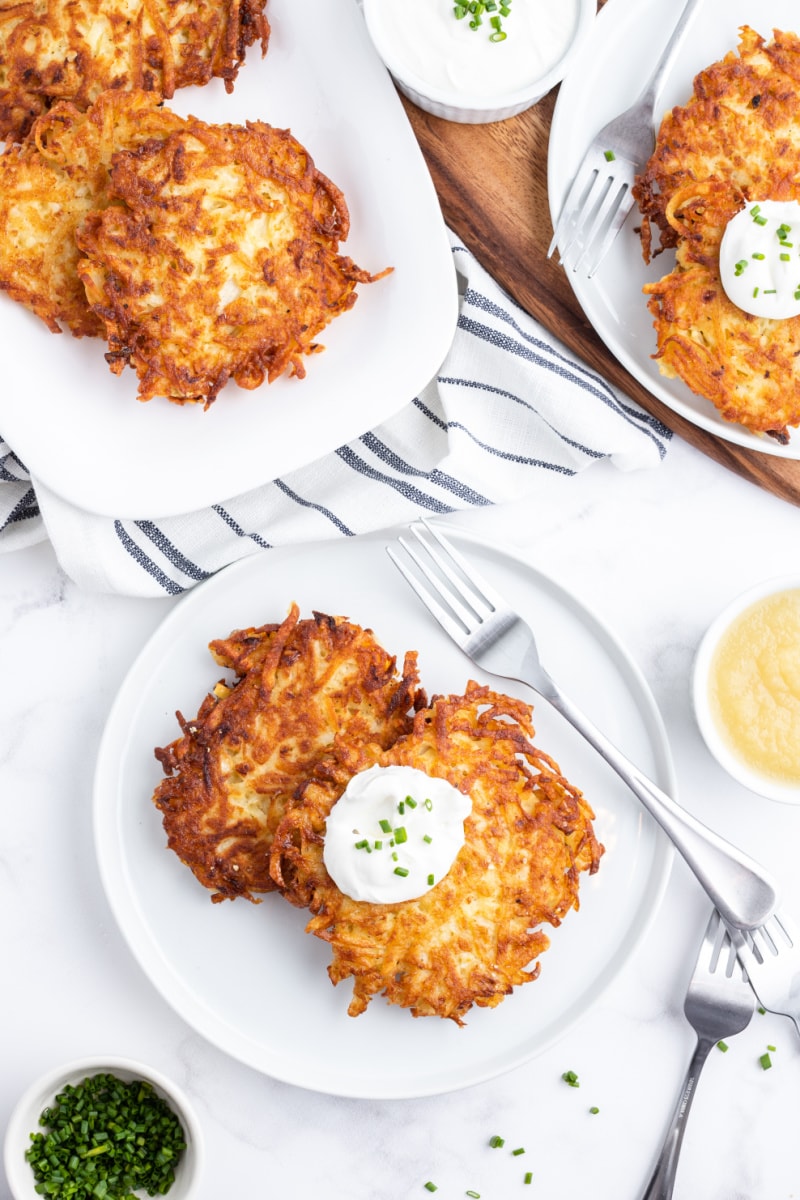 potato latkes on a plate with sour cream