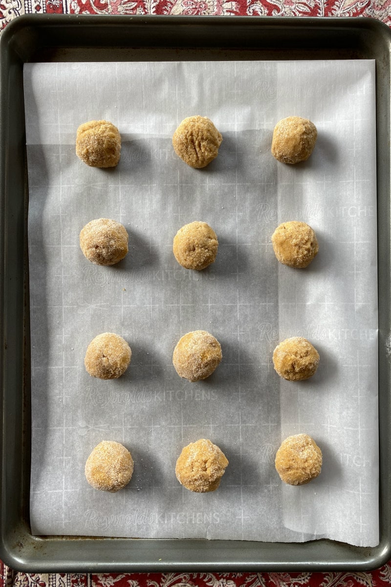 pumpkin snickerdoodle cookie dough balls on baking sheet