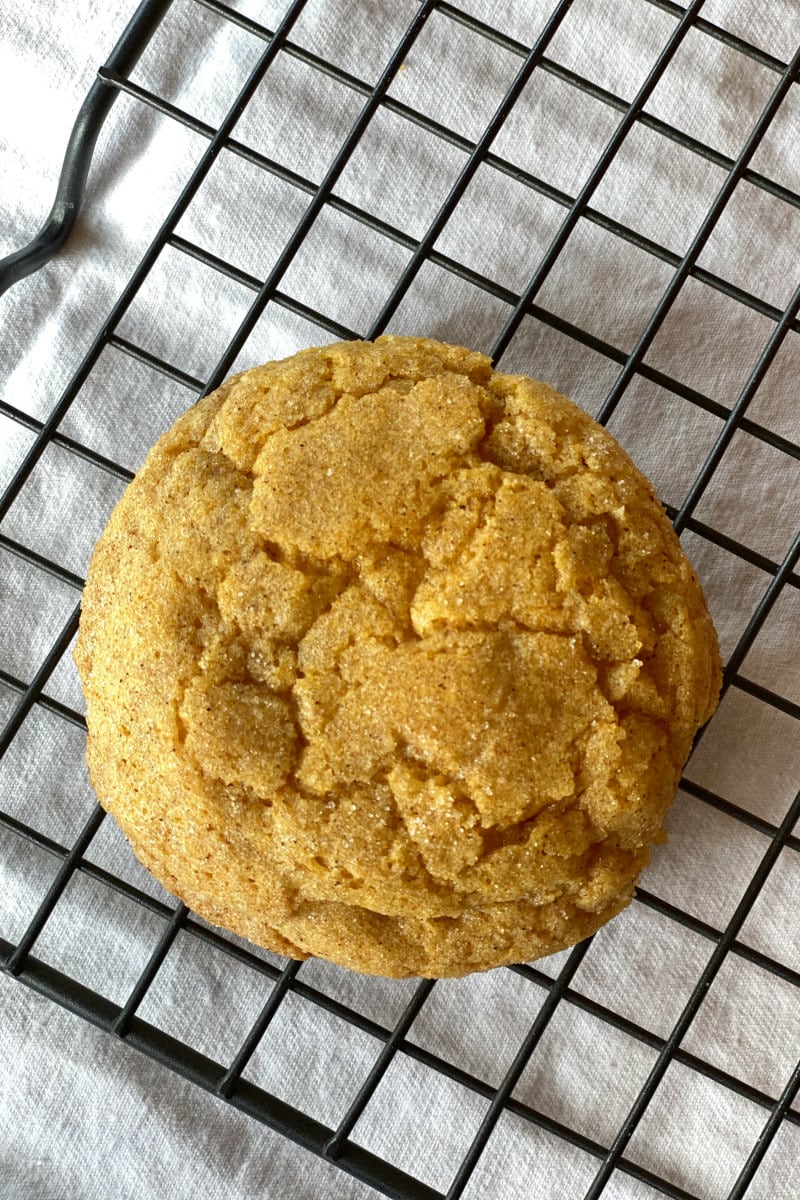 pumpkin snickerdoodle cookie on cooling rack