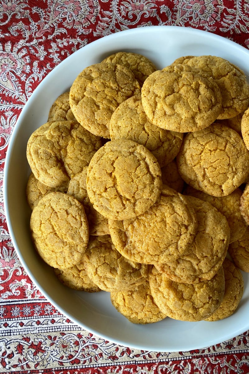 pumpkin snickerdoodle cookies piles on white platter