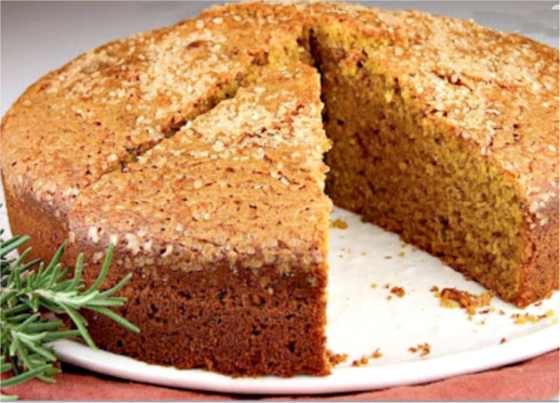 rosemary polenta pumpkin spice cake with slice taken out of it