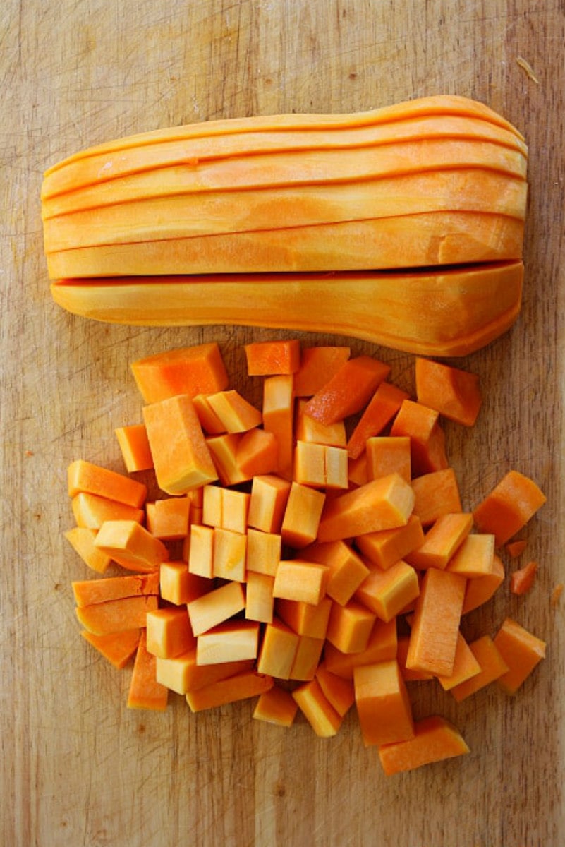 chopping butternut squash on cutting board