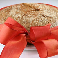 rosemary polenta pumpkin spice cake with a ribbon around it